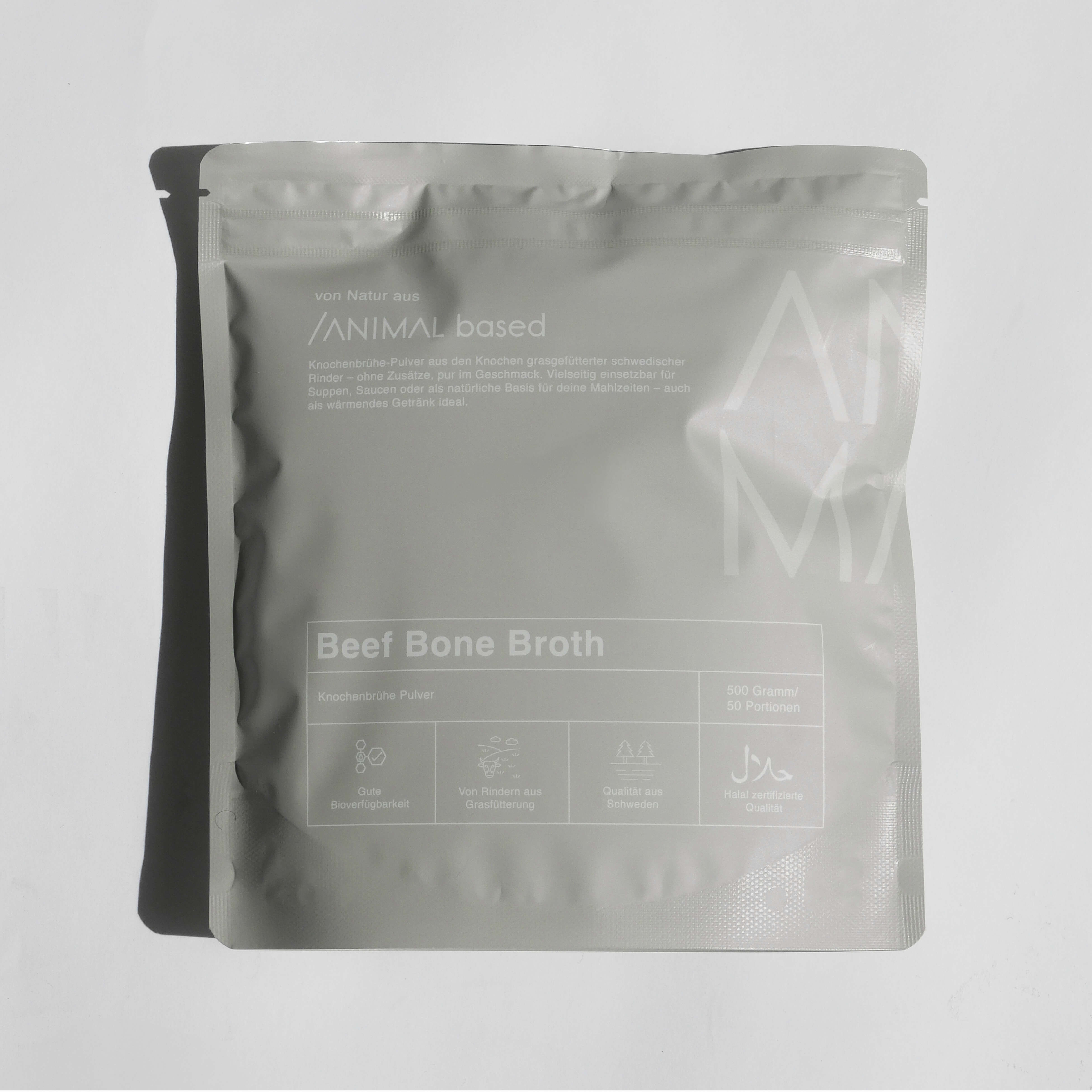 Close-up of a single green leaf against a white background.