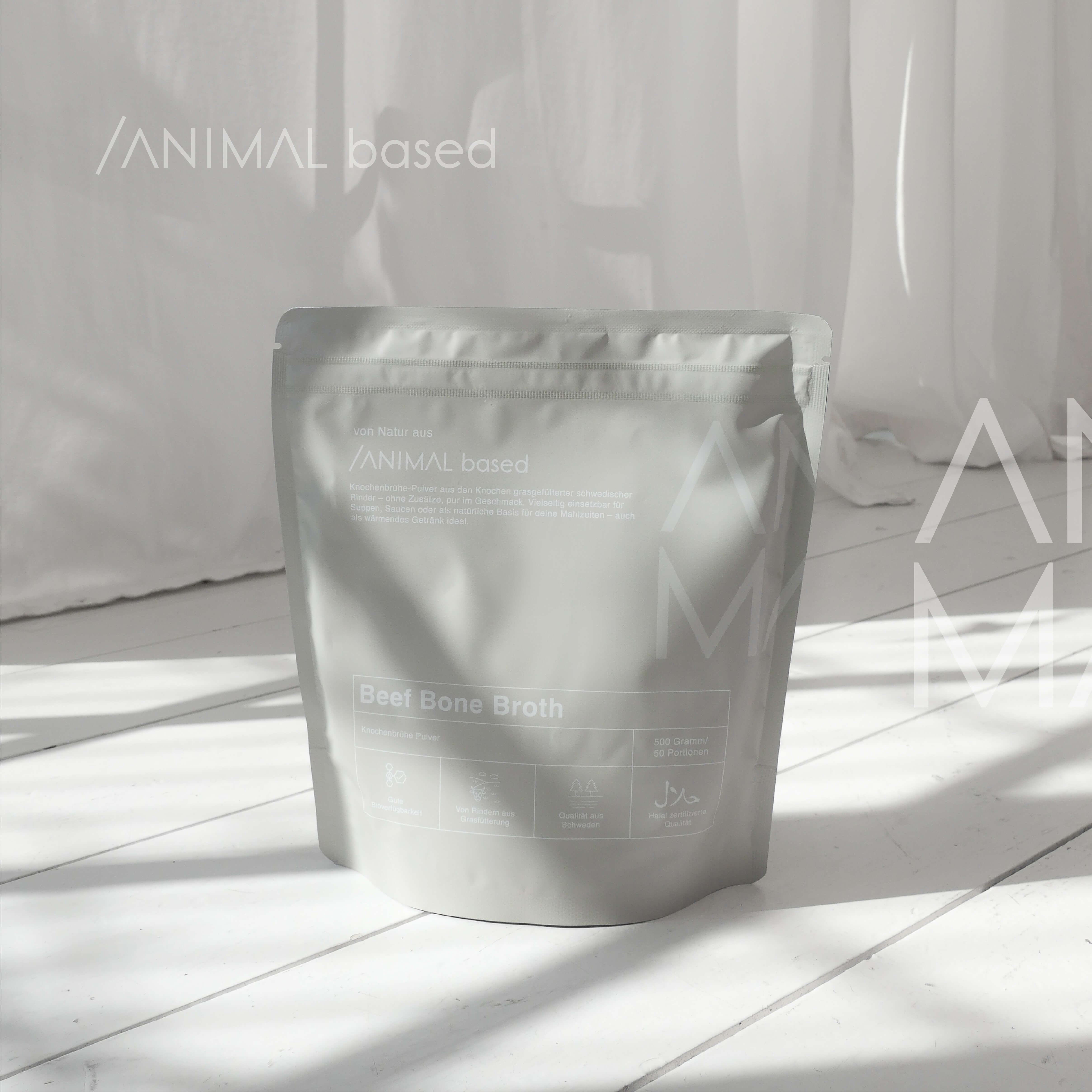 Close-up of a single green leaf against a white background.